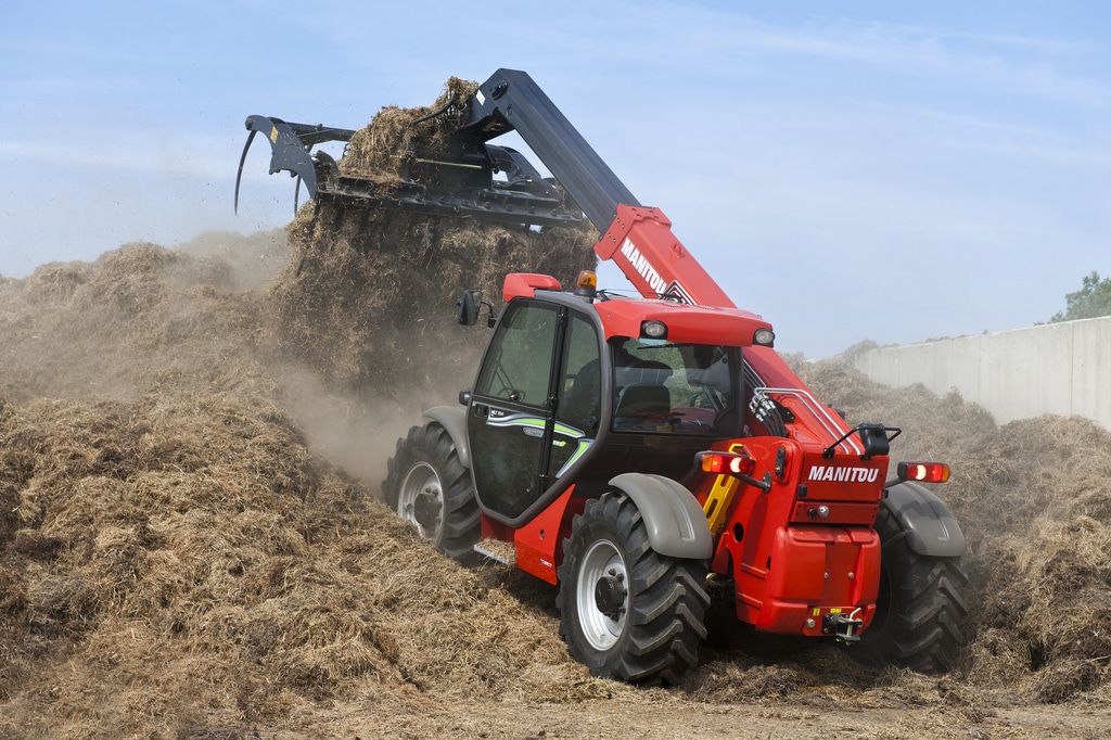 Red Farm Equipment picking up straw