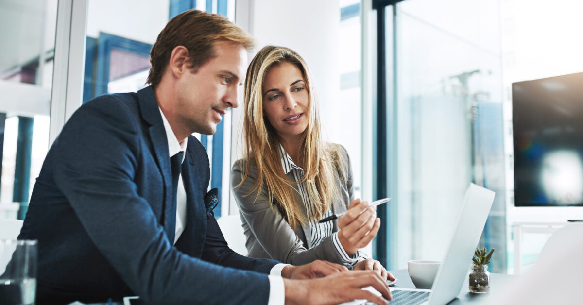 Man, woman and laptop with corporate partner, planning or typing for project, proposal and company vision. Businessman, partnership and computer with discussion, teamwork and consulting with analysis