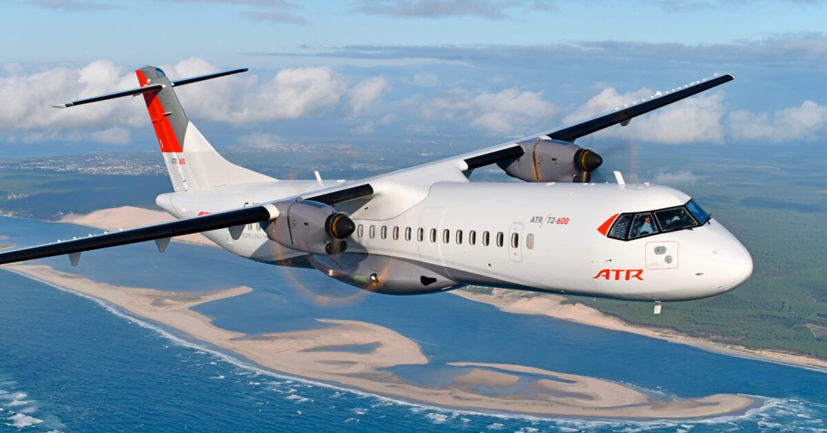 ATR airplane in sky with ocean in background